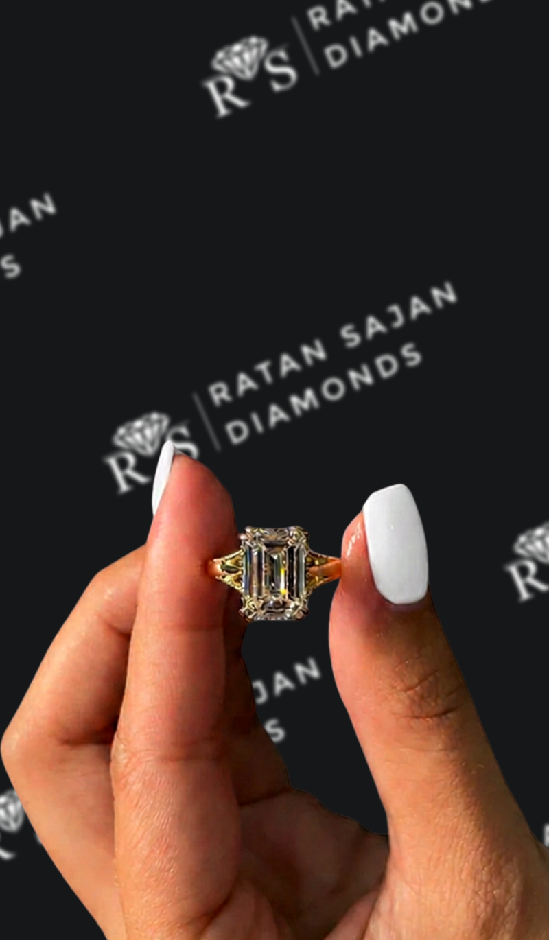 Four carat emerald cut natural diamond trilogy engagement ring