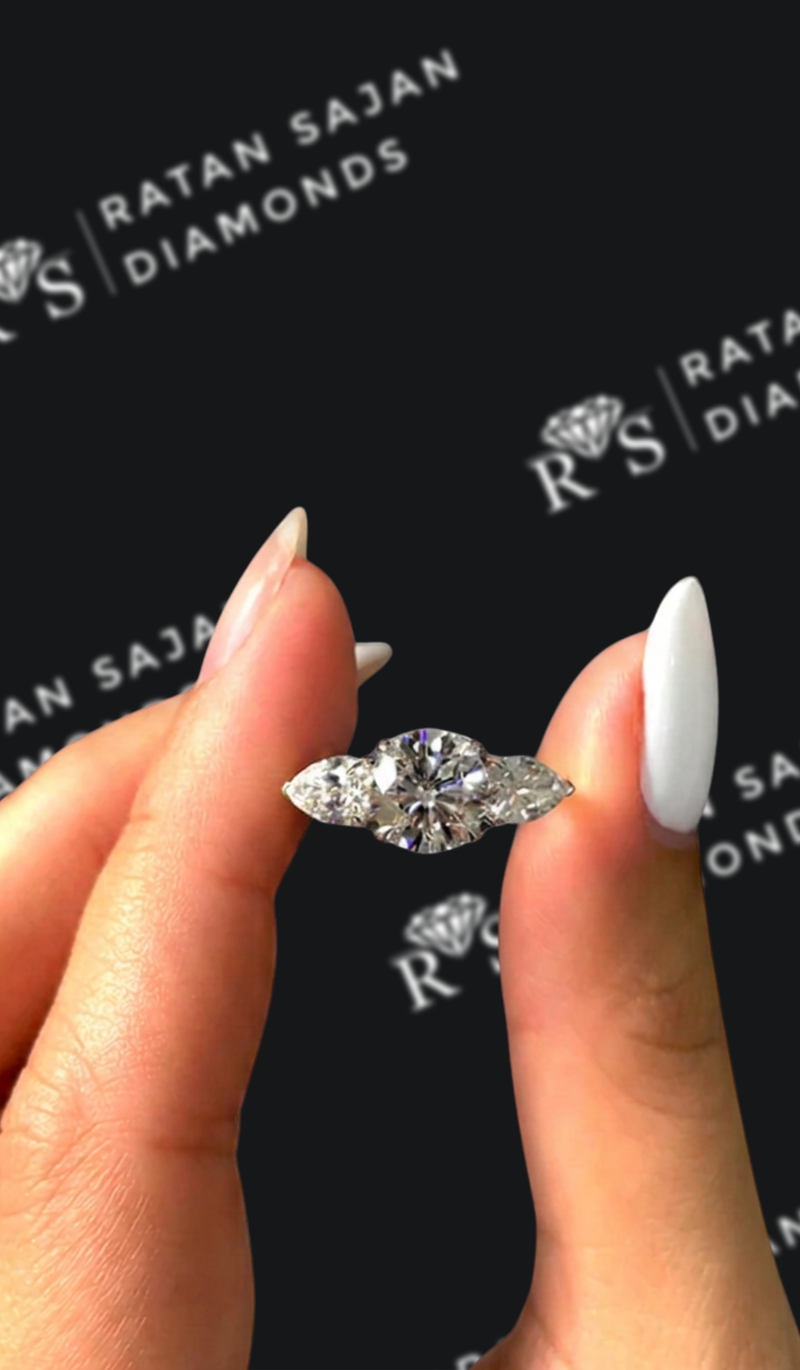 One-and-a-half carat round brilliant natural diamond trilogy engagement ring
