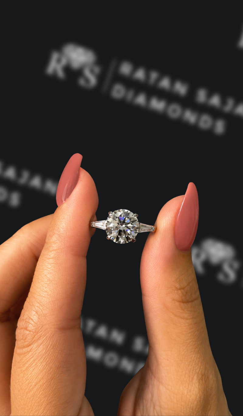 Two-and-a-half carat round brilliant natural diamond trilogy engagement ring