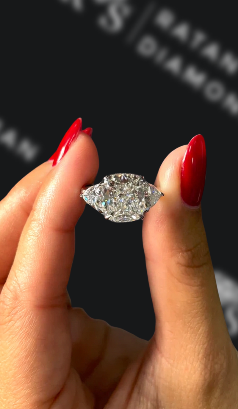 Four carat cushion cut natural diamond trilogy engagement ring