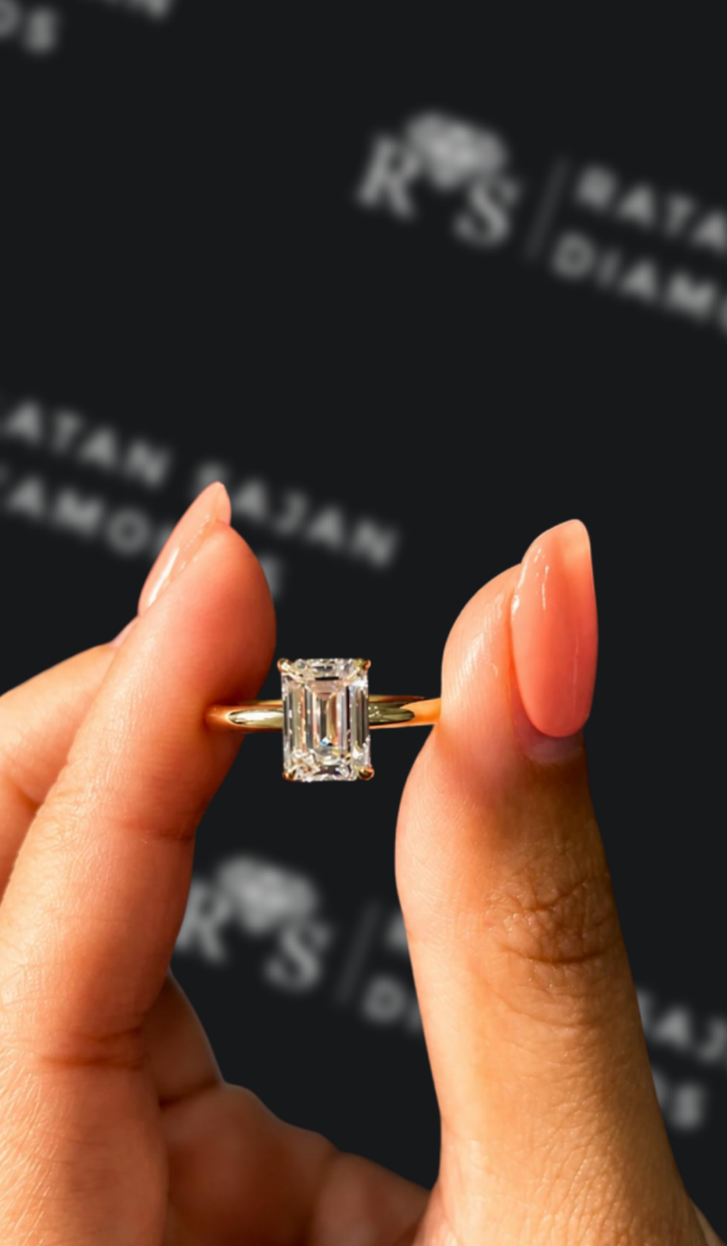 One-and-a-half carat emerald cut natural diamond solitaire engagement ring