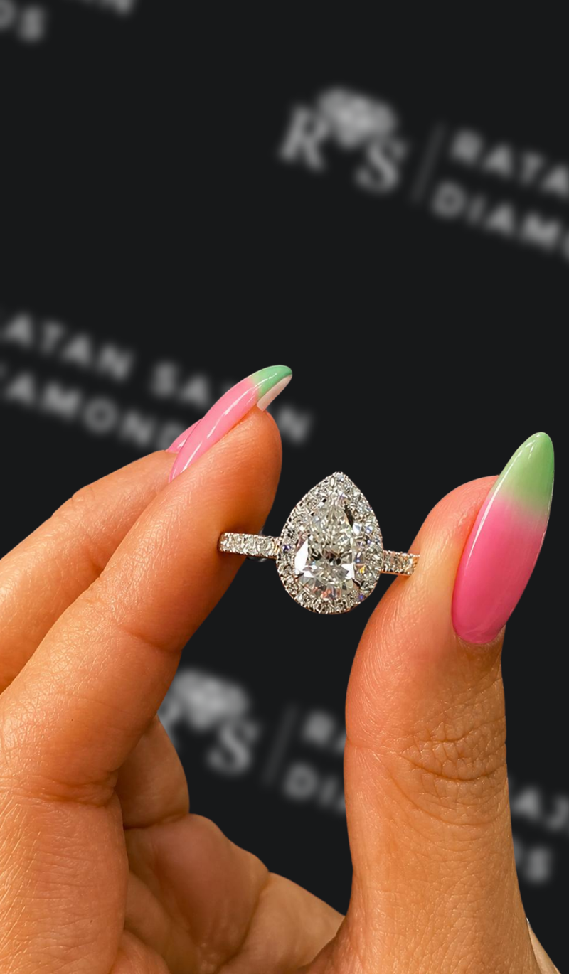 One carat pear shaped natural diamond halo engagement ring
